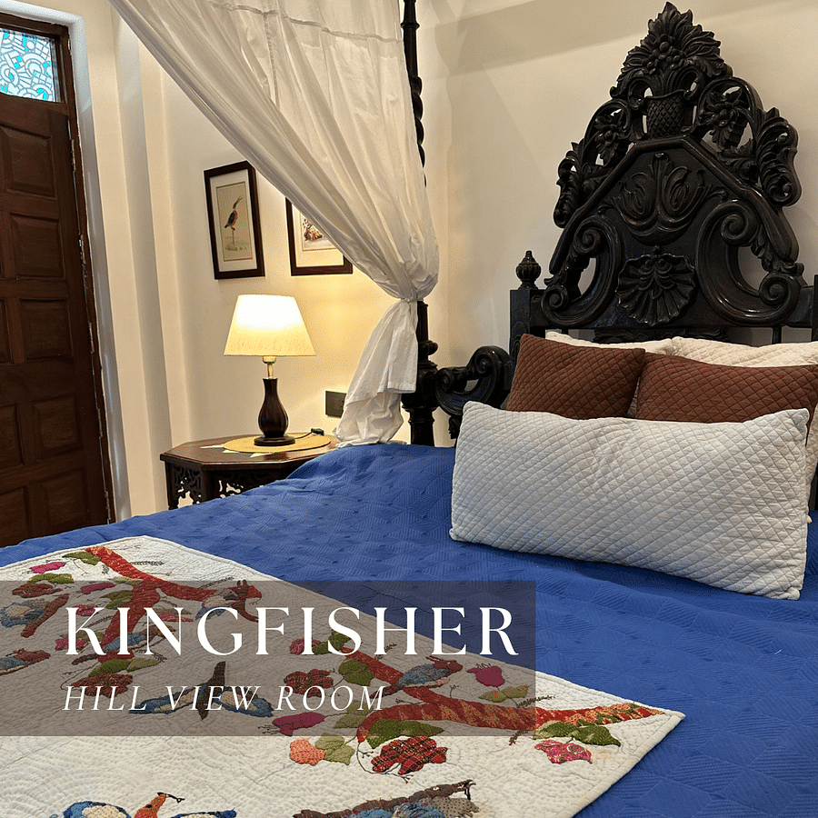 A four-poster bed with a quilt - Kingfisher Hill View Room.